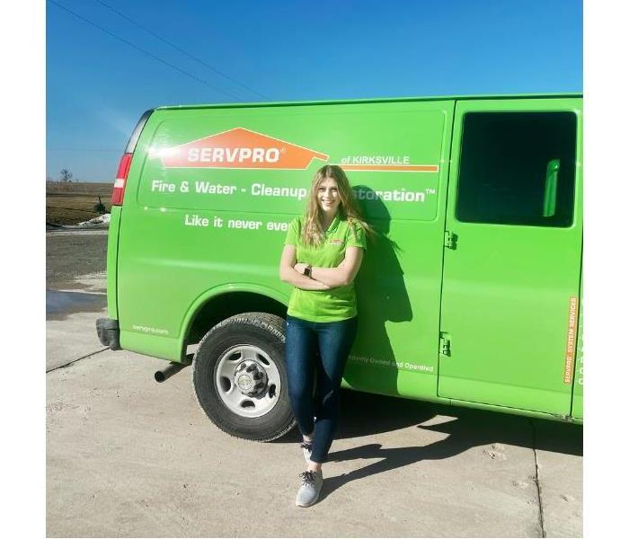 Join the team! Female smiling by SERVPRO vehicle.